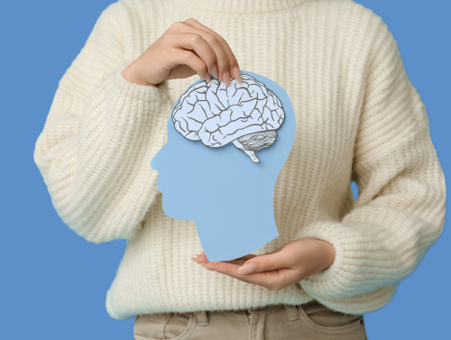 Person holding paper cut out of brain